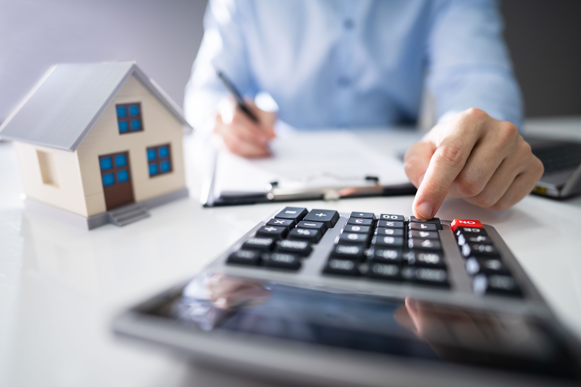 Businessman's Hand Calculating Invoice