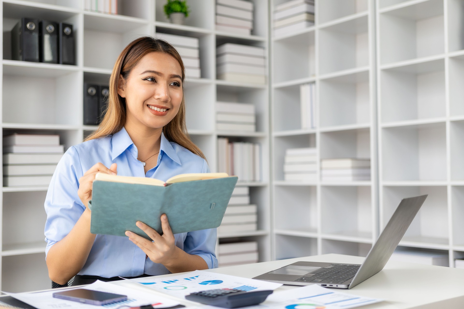 Asian female financial accountant working checking financial documents at home must use calculator to calculate before paying tax receipt online. Business budget planning