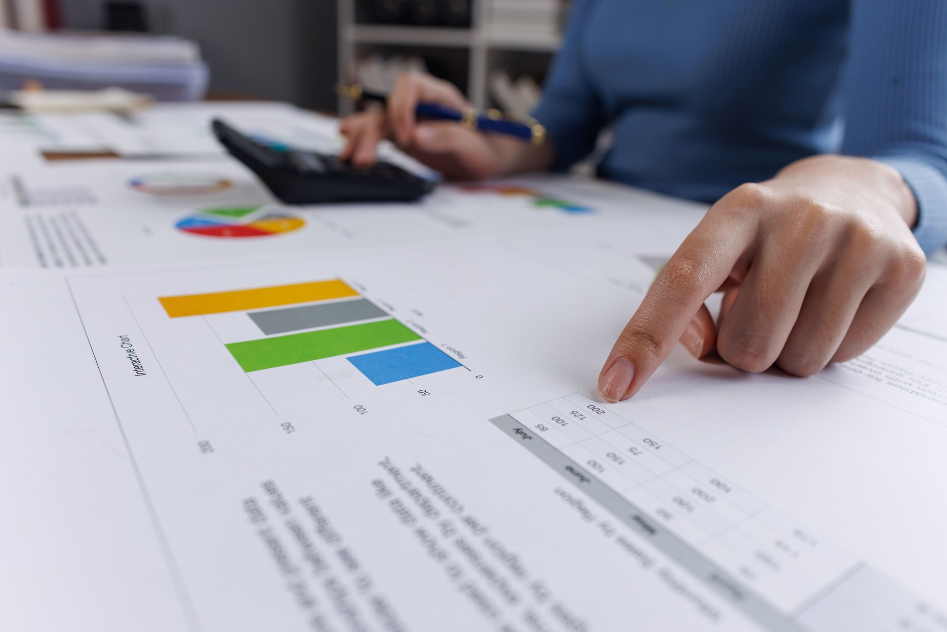 Young Asian businesswoman uses a calculator to calculate business principles. Accounting statistical concepts at the office starting a financial business, calculating accounting online marketing.